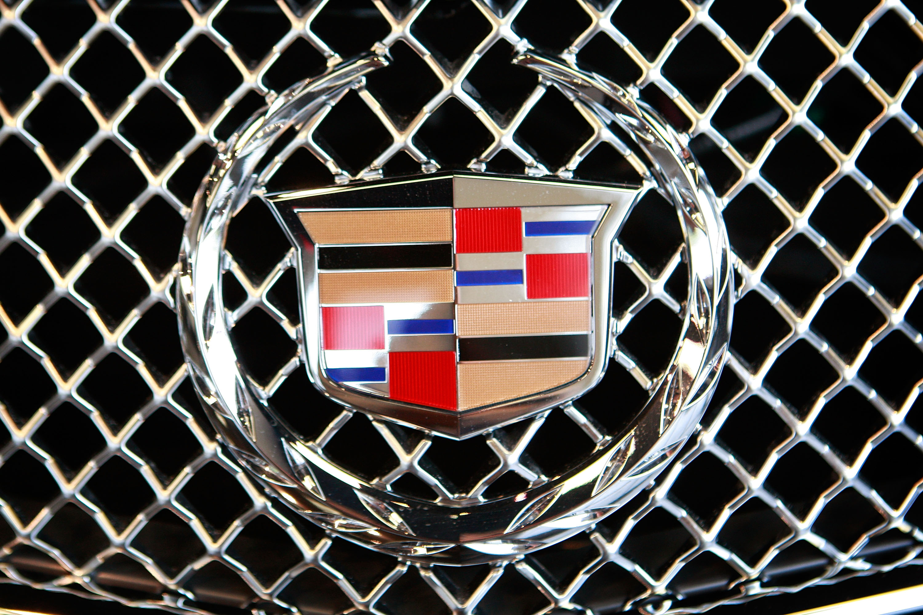 A Cadillac emblem decorates the grill of an Escalade offered for sale at Grossinger's GM dealership May 13, 2009 in Lincolnwood, Illinois. In an attempt to shore up the industry General Motors announced plans to cut 2600 dealerships while Chrysler has made plans to eliminate about 850.