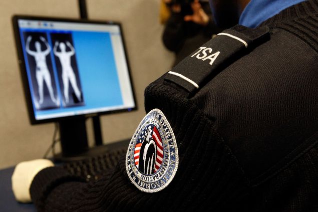 Transportation Security Administration Security Officer Nyamsi Tchapleu looks at images created by a "backscatter" scanner.