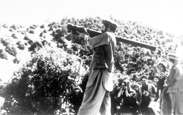 An Afghan Mujahideen demonstrates positioning of a hand-held surface-to-air missile.