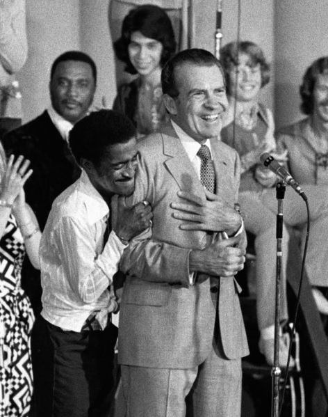 Entertainer Sammy Davis Jr. hugs President Richard Nixon at a youth rally in Miami, Aug. 22, 1972.