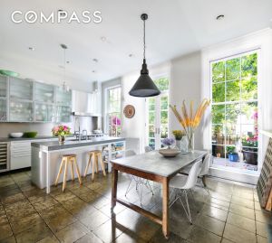 The kitchen, with "modern" cabinetry and with terra-cotta floors.