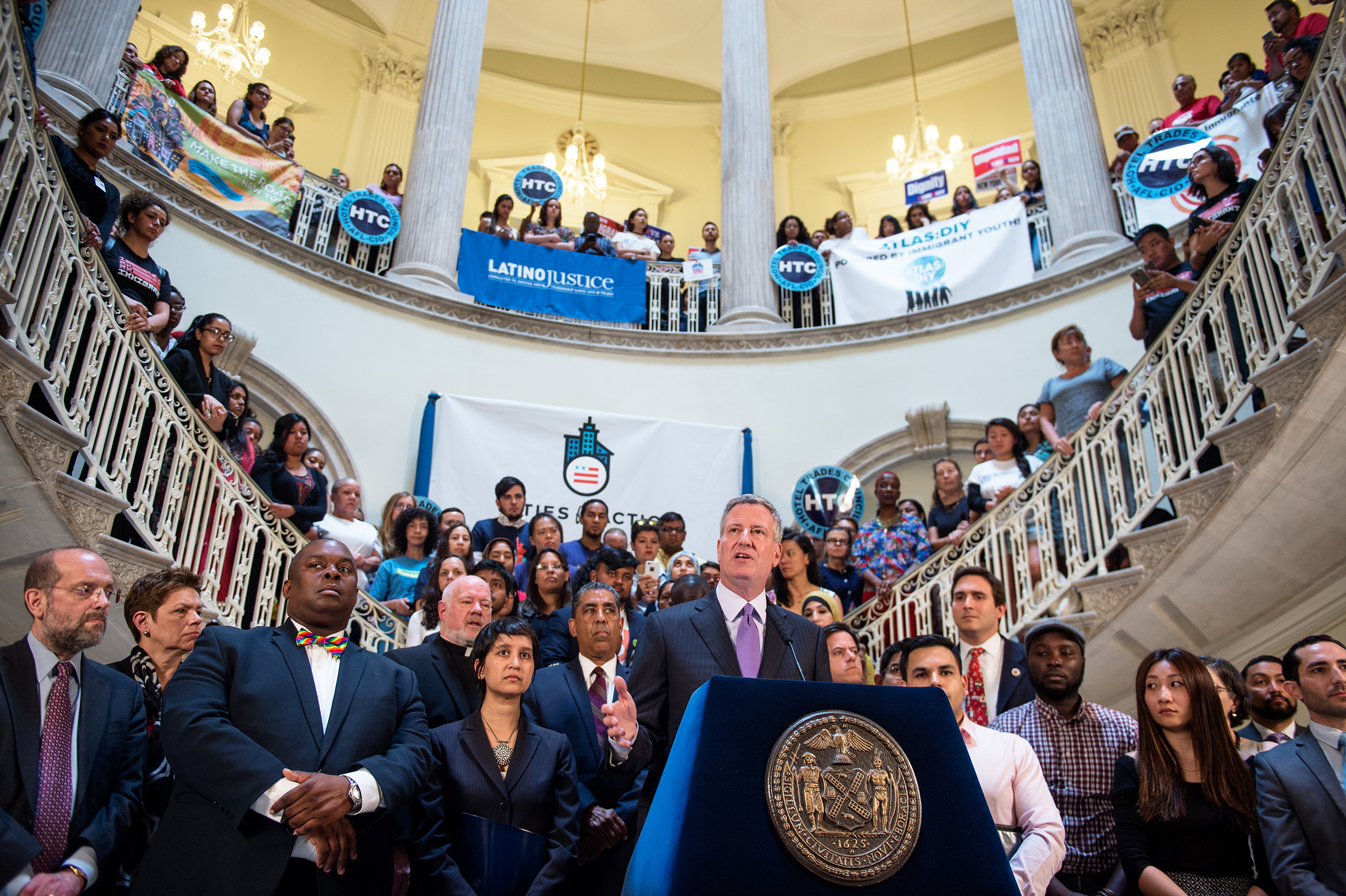 Mayor Bill de Blasio leads a rally in the City Hall rotunda.