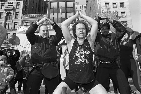 American fitness guru Richard Simmons, center, is joined by two policemen and others in an outdoor workout session sponsored by the California Raisin Marketing Board on February 10, 2000 in Union Square Park, New York City, New York.