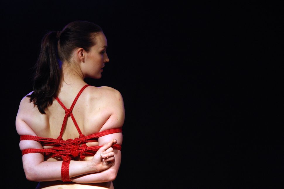 BERLIN, GERMANY - OCTOBER 18: A model poses during a bondage demonstration at the 2012 Venus Erotic Fair at Messe Berlin on October 18, 2012 in Berlin, Germany. The trade fair for the adult entertainment industry will be open from October 18 through 21.