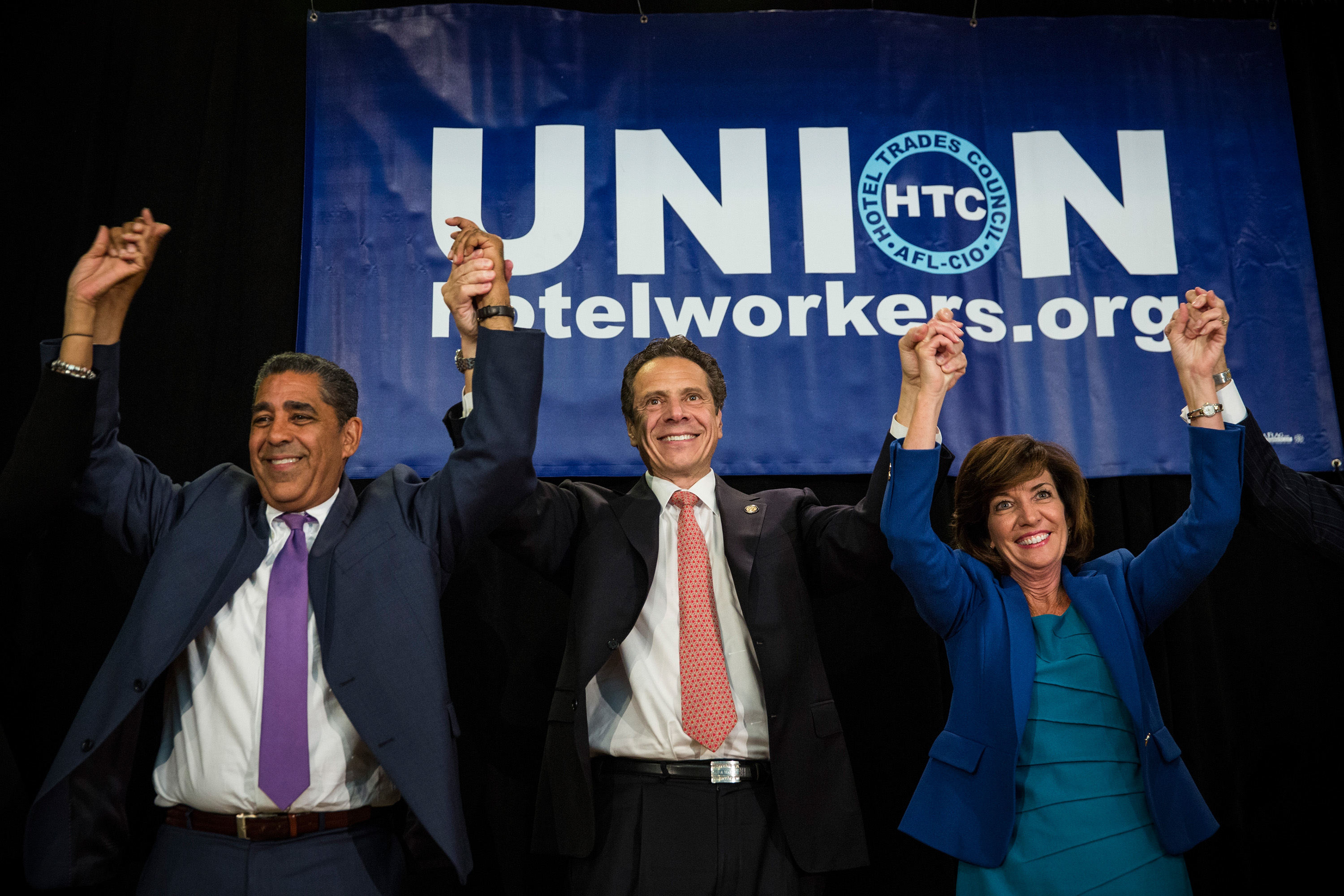 New York Governor Andrew Cuomo (C), his choice for Lieutenant Governor, former congresswoman Kathy Hochul (R) and New York State Senator Adriano Espaillat campaign together at the Hotel Trade Council during a reelection campaign event on September 8, 2014 in New York City.