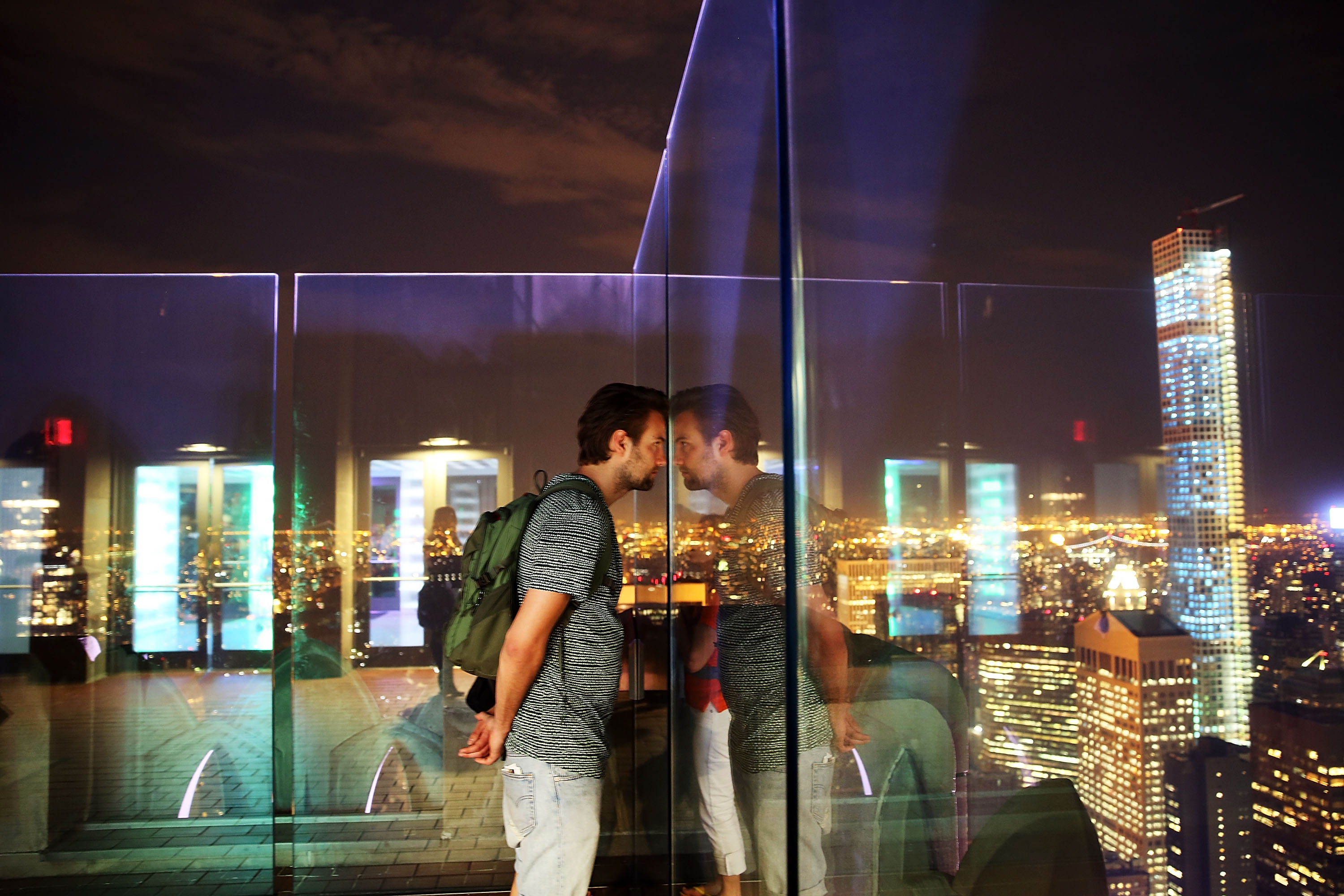 A man looks out over Manhattan.