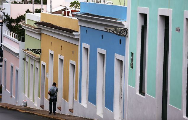A pedestrian walks through a street in Old San Juan as the island's residents deal with the government's $72 billion debt on July 1, 2015 in San Juan, Puerto Rico. Governor of Puerto Rico Alejandro Garc?a Padilla said in a speech recently that the people of Puerto Rico will have to make sacrifices and share the responsibilities to help pull the island out of debt.