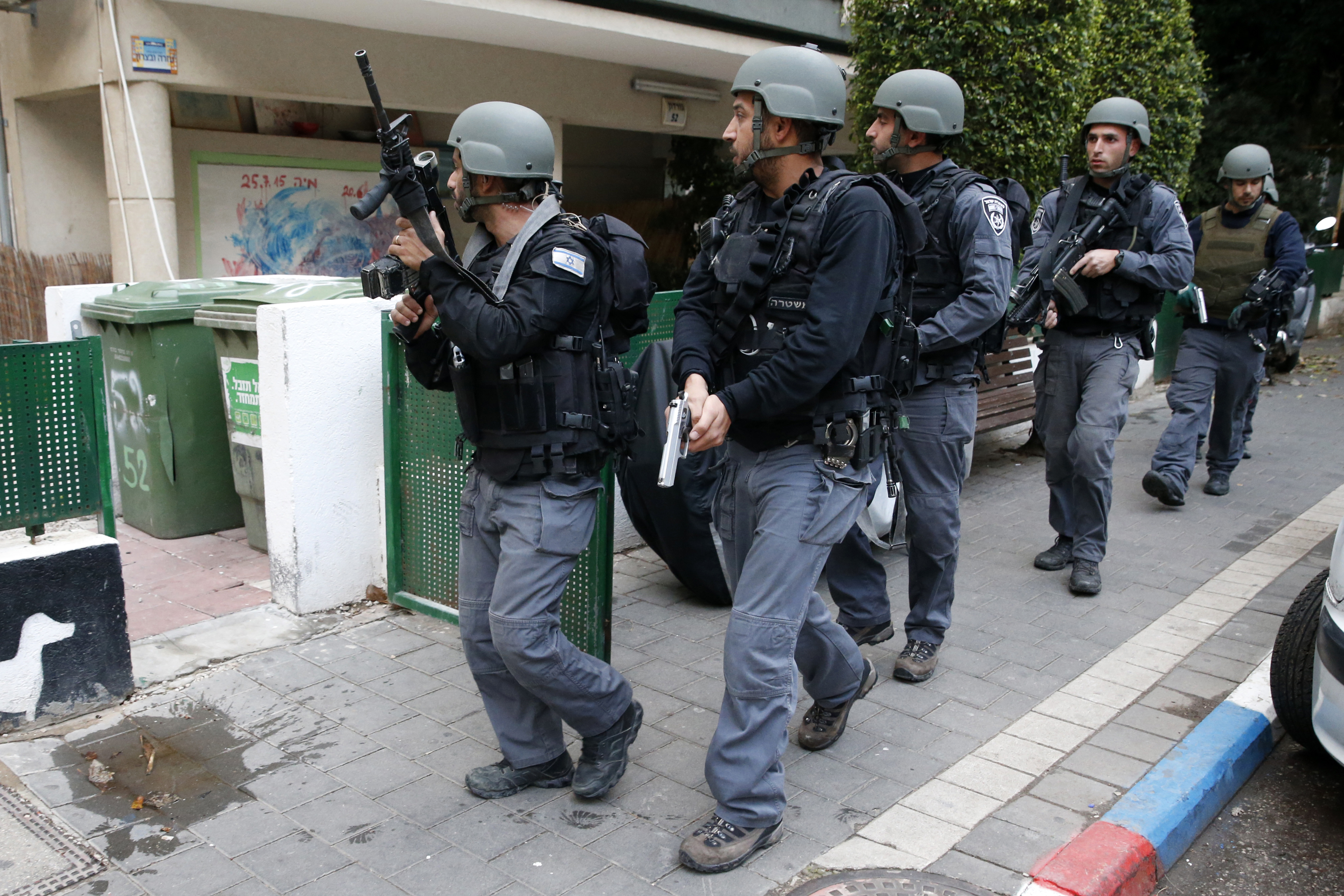 Members of the Israeli security forces search the area following an attack by an unidentified gunman, who opened fire at a pub in the Israeli city of Tel Aviv killing two people and wounding at least seven others on January 1, 2016, police and medical officials said. An eyewitness told Channel 1 television the assailant used an automatic weapon against people at a pub. AFP PHOTO / JACK GUEZ / AFP / JACK GUEZ