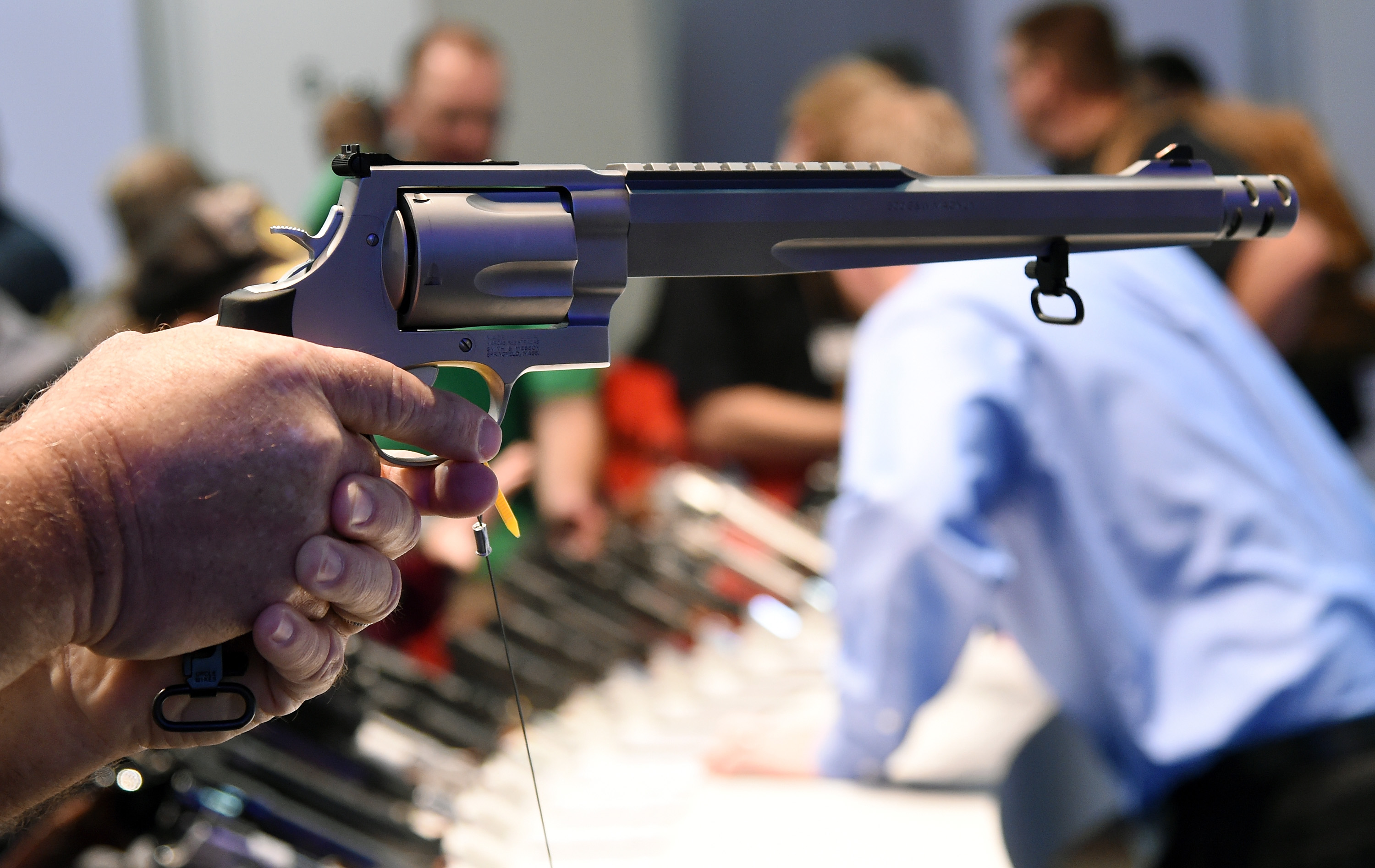 A convention attendee tries out a model S&W500 Magnum 10.5-inch barrel handgun at the Smith & Wesson booth at the 2016 National Shooting Sports Foundation's Shooting, Hunting, Outdoor Trade (SHOT) Show at the Sands Expo and Convention Center on January 19, 2016 in Las Vegas, Nevada. The SHOT Show, the world's largest annual trade show for shooting, hunting and law enforcement professionals, runs through January 23 and is expected to feature 1,600 exhibitors showing off their latest products and services to more than 62,000 attendees.