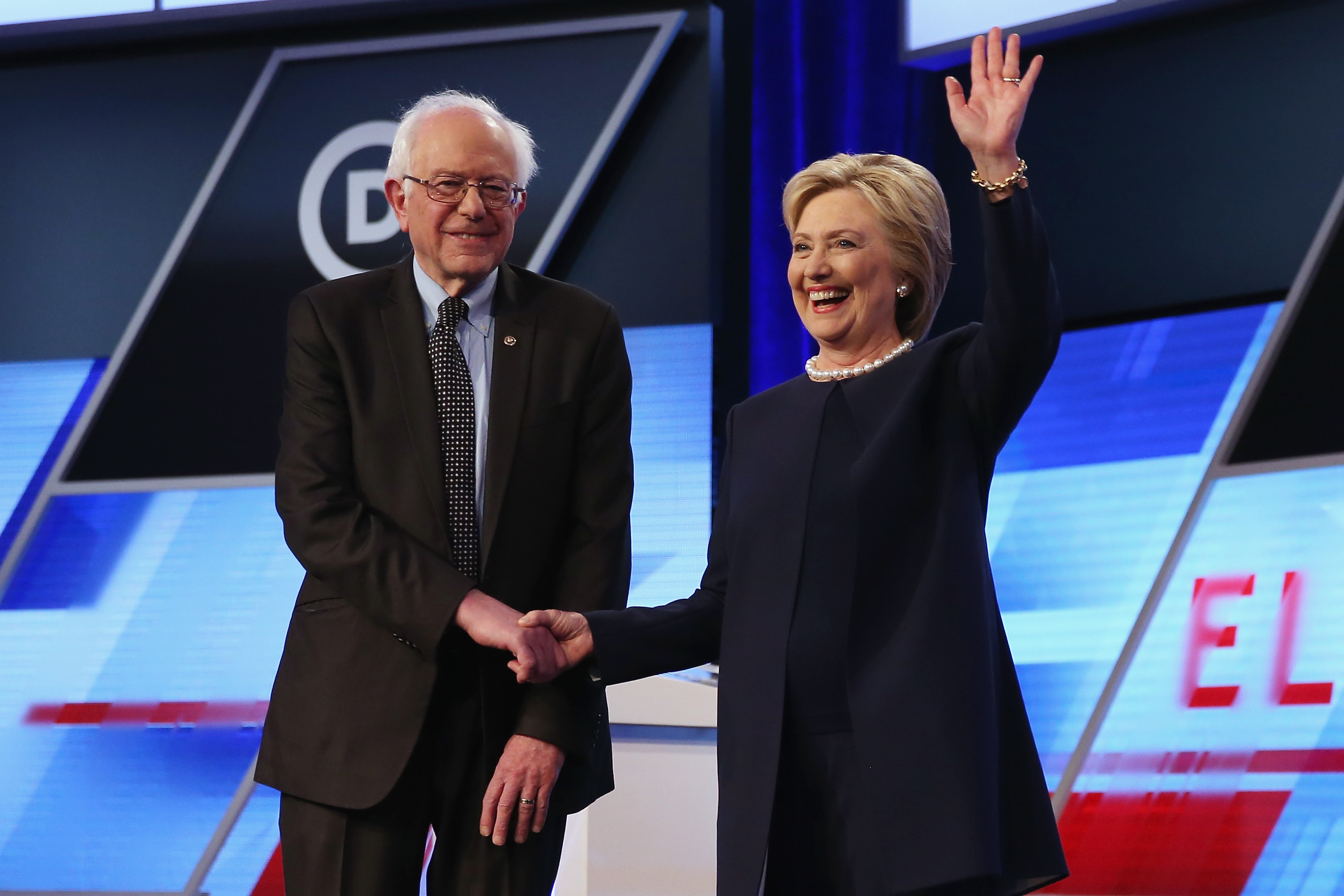 Democratic presidential candidates Senator Bernie Sanders and Hillary Clinton shake hands at a debate in March.