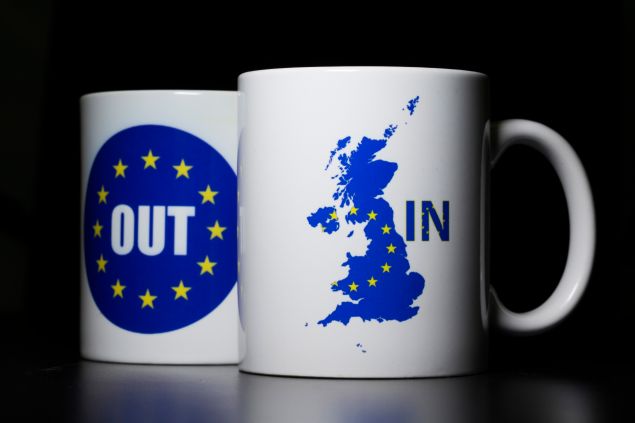 LONDON, UNITED KINGDOM - MARCH 17: In this photo illustration, the words 'IN' and 'OUT' are depicted on mugs on March 17, 2016 in London, United Kingdom. The United Kingdom will hold a referendum on June 23, 2016 to decide whether or not to remain a member of the European Union (EU), an economic and political partnership involving 28 European countries which allows members to trade together in a single market and free movement across its borders for citizens.