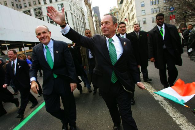 Former New York City Mayor Rudy Giuliani (L) and current New York City Mayor Michael Bloomberg wave to the crowd during the St. Patrick's Day Parade March 17, 2005 in New York.