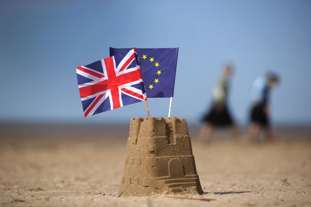 In this photo illustration the flag of the European Union and the Union flag sit on top of a sand castle on a beach on May 09, 2016 in Southport, United Kingdom. 