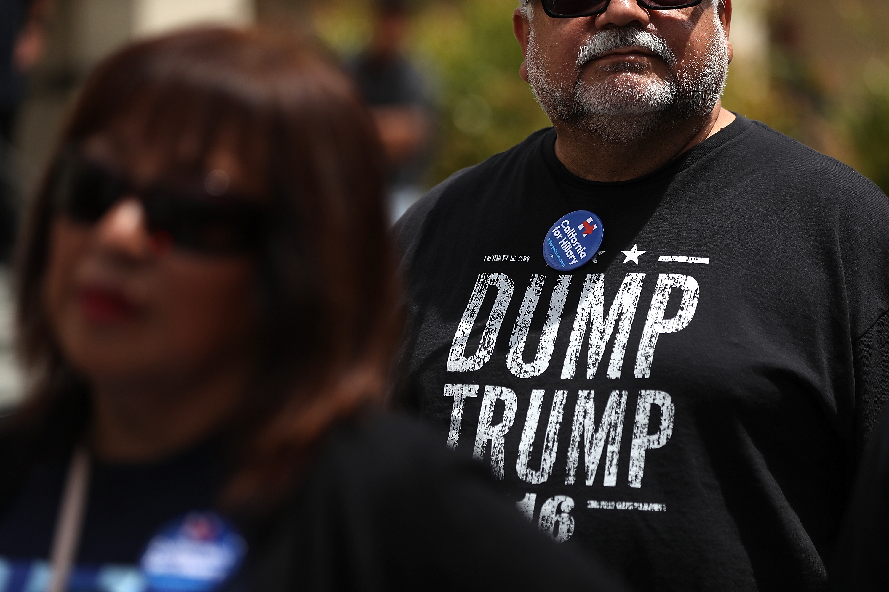 SALINAS, CA - MAY 25: A supporter of democratic presidential candidate former Secretary of State Hillary Clinton wears a "Dump Trump" shirt before a campaign rally at Harrell College on May 25, 2016 in Riverside, California. Hillary Clinton is campaigning in California ahaed of the State's presidential primary on June 7th.