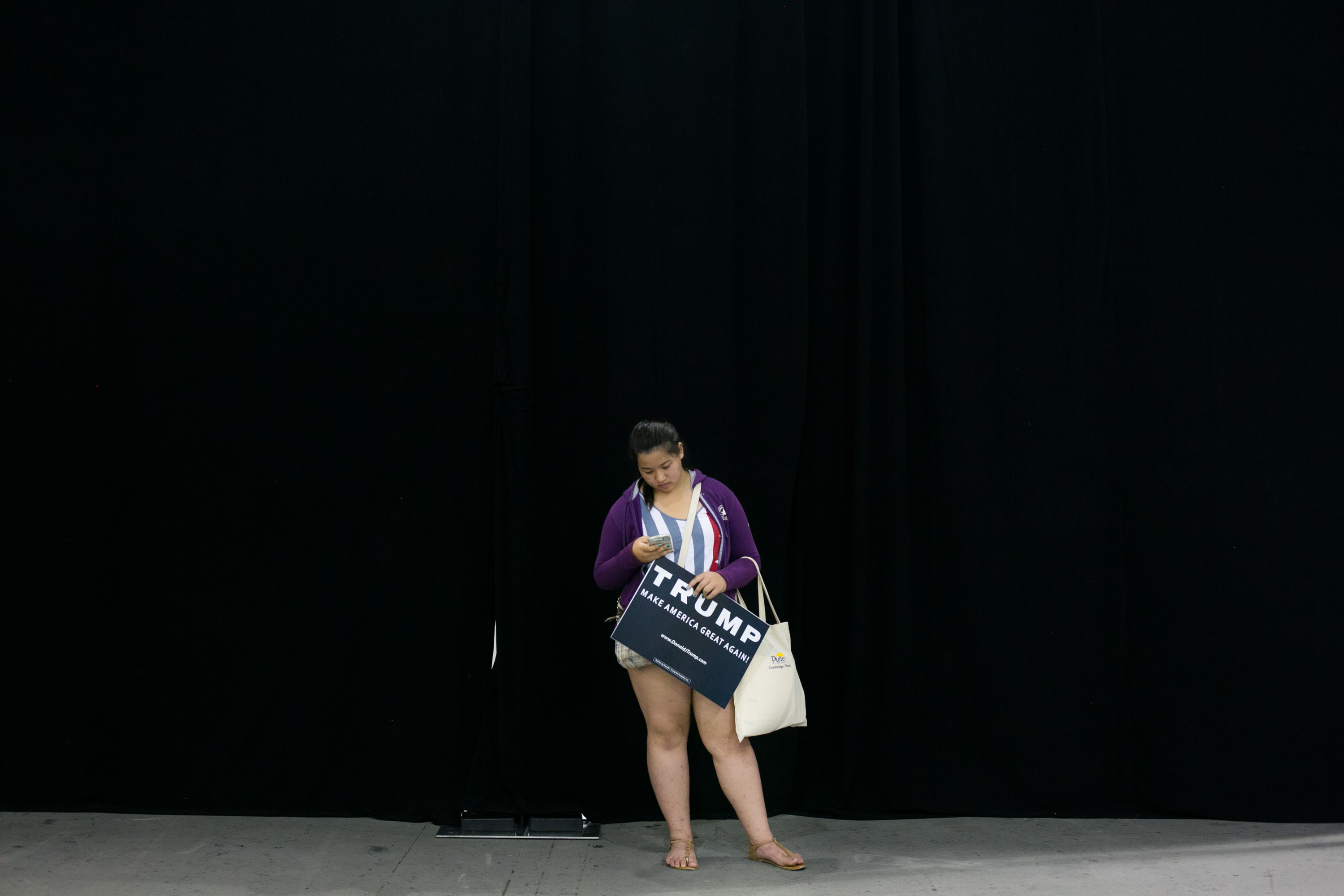 SAN JOSE, CA - JUNE 02: Megan Johanson, 15, of Cupertino, California, texts as she waits for her mom prior to a campaign rally for Republican presidential candidate Donald Trump on June 2, 2016 in San Jose, California. California. The California primary is June 7.