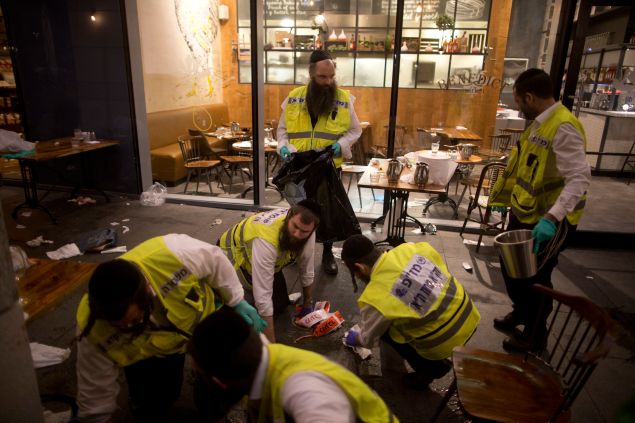 Members of an Israeli ZAKA - Identification, Extraction and Rescue team work at the scene of a shooting outside Max Brenner restaurant in Sarona Market on June 8, 2016 in Tel Aviv, Israel.