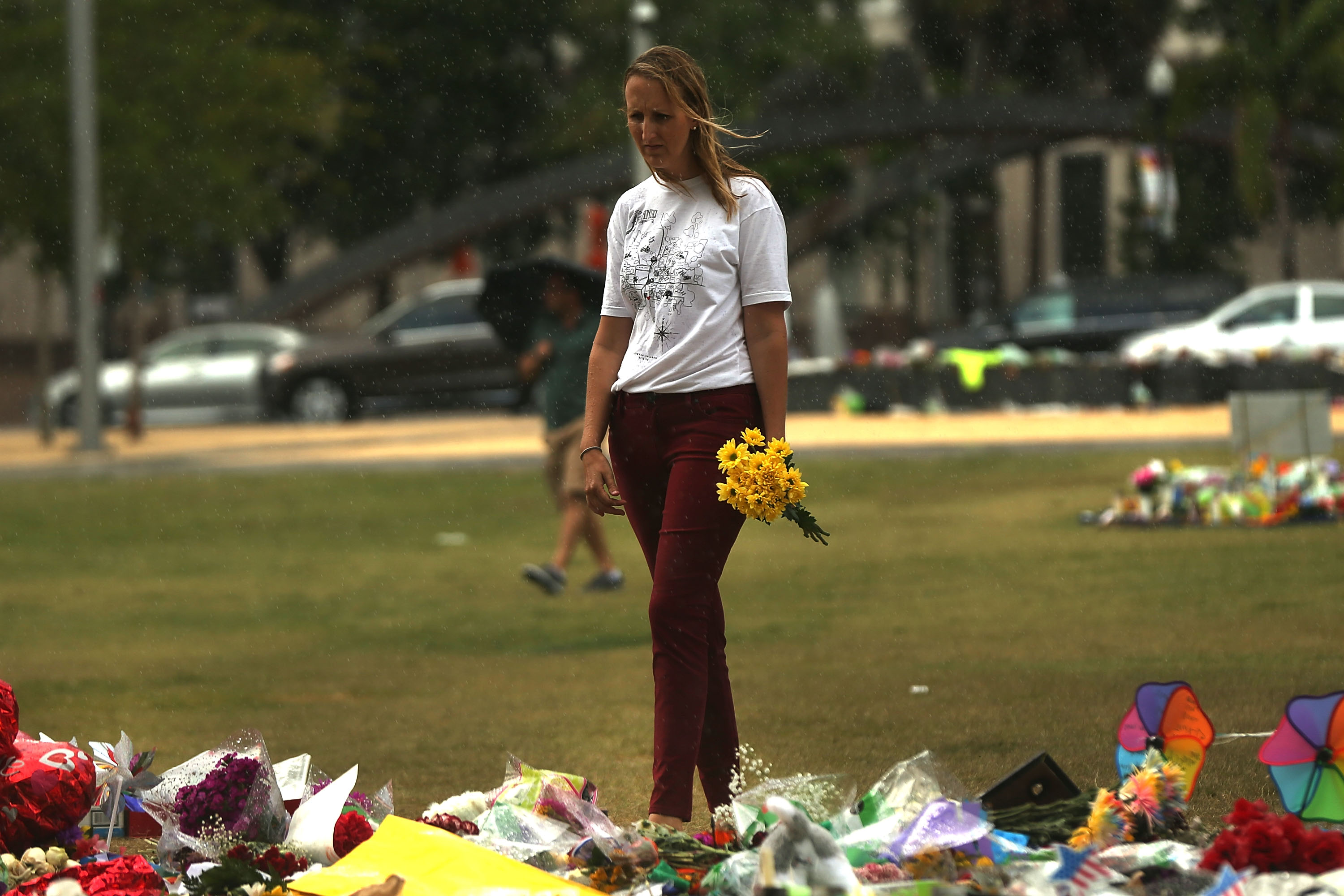 A woman visits a memorial for those killed at the Pulse nightclub last Saturday night on June 16, 2016 in Orlando, Florida. Omar Mir Seddique Mateen shot the victims in what appears to be an ISIS inspired attack in which 49 people were killed early Sunday and 53 people were wounded.