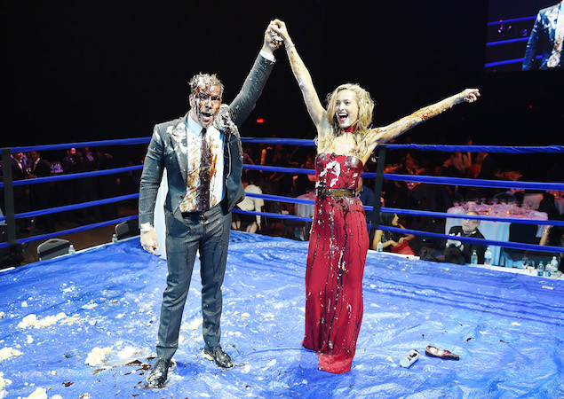 The comedian and the model in the ring, post-cake.