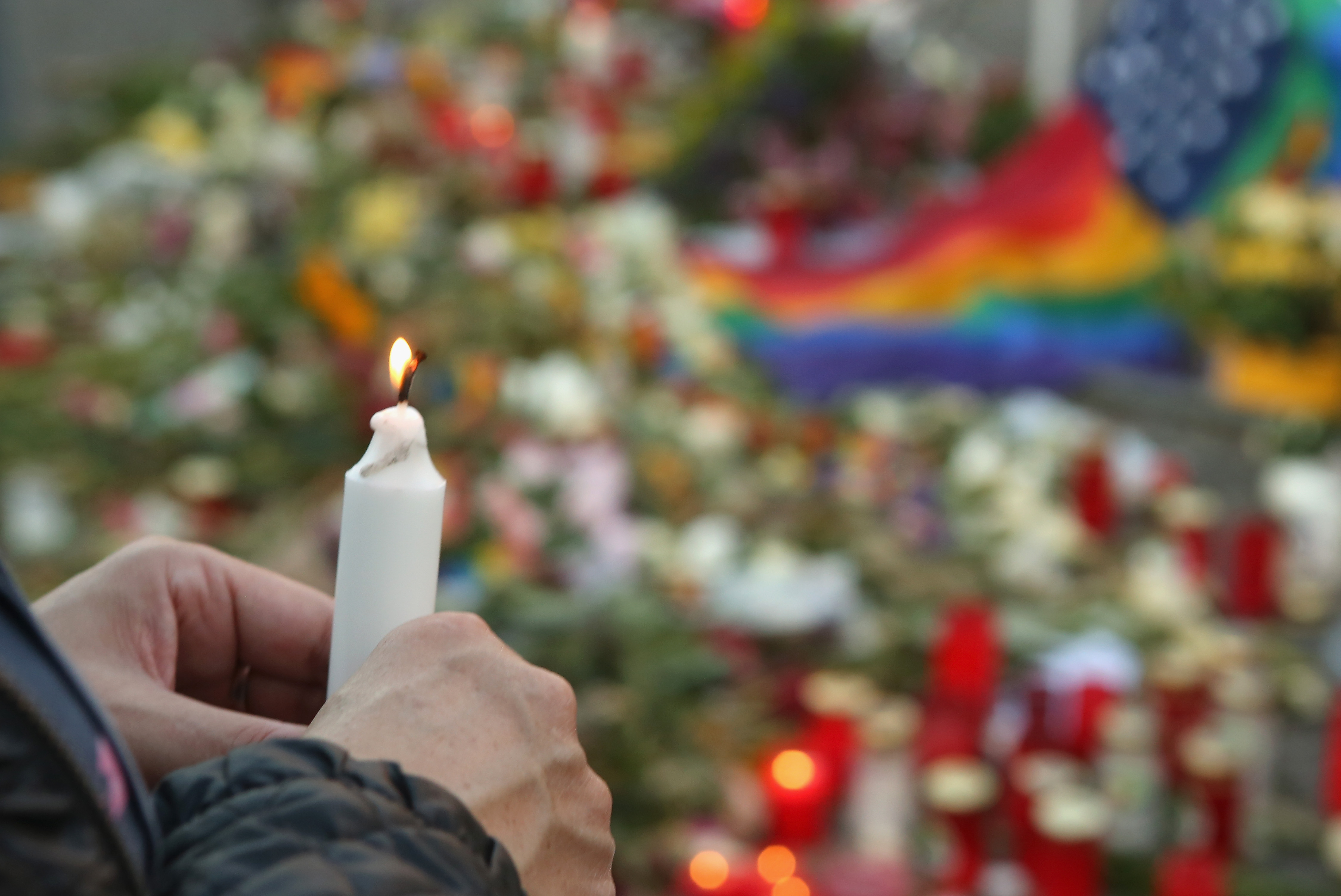 A mourner attends a vigil for victims of a shooting at a gay nightclub in Orlando, Florida nearly a week earlier, in front of the United States embassy on June 18, 2016 in Berlin, Germany. Fifty people were killed and at least as many injured during a Latin music event at the Pulse club in the worst terror attack in the U.S. since 9/11. The American-born gunman had pledged allegiance to ISIS, though officials have yet to find conclusive evidence of his having any direct connection with foreign extremists. The incident has added fuel to the ongoing debate about gun control in the country. 