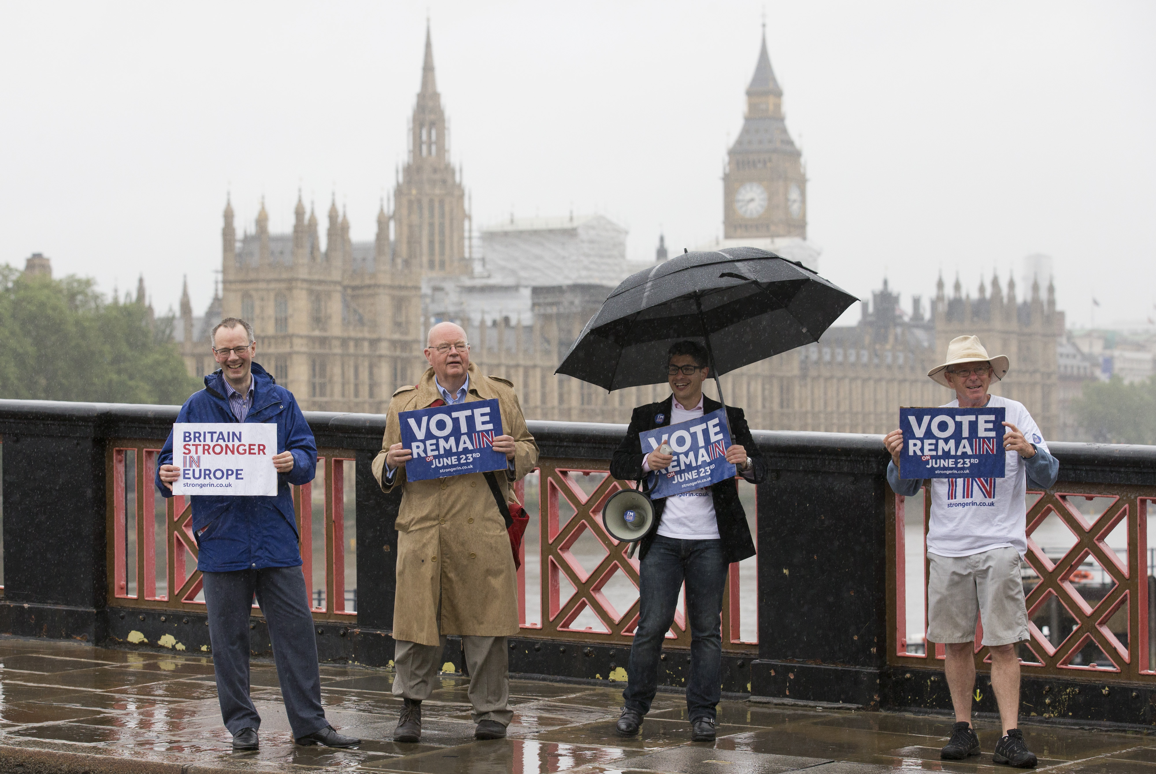 Campaigners hold placards for 'Britain Stronger in Europe', the official 'Remain' campaign group seeking to avoid a Brexit, ahead of the forthcoming EU referendum, in London on June 20, 2016.