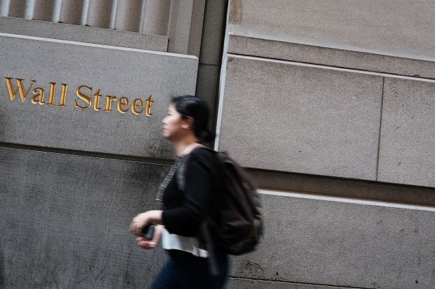 NEW YORK, NY - JUNE 24: People walk by the New York Stock Exchange (NYSE) on Wall Street following news that the United Kingdom has voted to leave the European Union on June 24, 2016 in New York City. The Dow Jones industrial average closed down over 600 points on the news with markets around the globe pluninging.