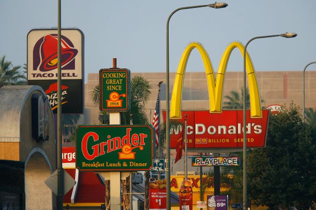 Signs for Taco Bell, Grinder, McDonalds, Panda Express fast-food restaurant line the streets in the Figueroa Corridor area of South Los Angeles on July 24, 2008, Los Angeles, California.