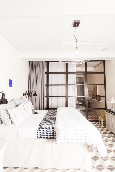 The airy bedroom with an Yves Klein painting