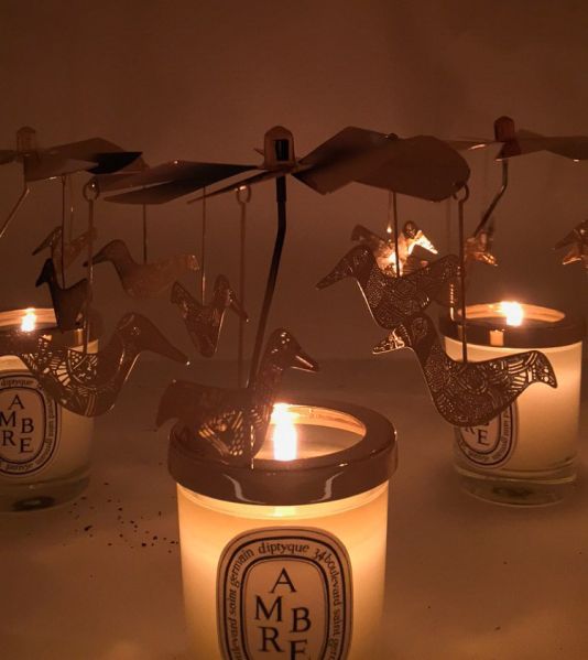 Carousel-adorned Amber candles seen inside the box