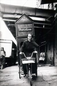 Joey Skaggs as a priest pedals his Portofess.