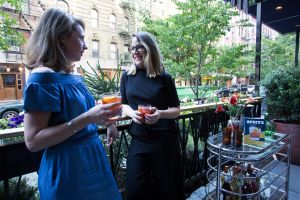 Authors Leslie Pariseau and Talia Baiocchi chat on the veranda at Sessanta.