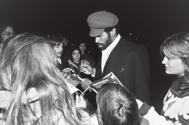 O.J. Simpson signs autographs outside Rich Stadium.