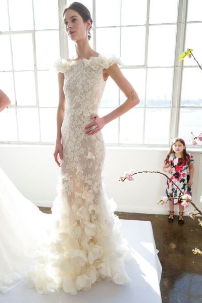 The Dress: A saucy skirt meets feminine details in this delightful fit-and-flare corded lace gown from Marchesa. Full-blown organza roses add a note of nostalgia to a summery frock that can stay up late.
