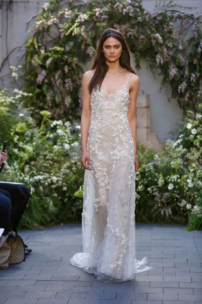 THE DRESS: As effortless as a wedding gown can be, Monique Lhuillier’s jeweled Chantilly lace slip dress requires no more than sun-kissed shoulders and a well-toned body. The nude lining keeps it legal.
