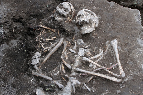 Archaelogists inspects a grave with a skeleton with an iron rod penetrated the heart body area, dated back in the Middle Ages in the ancient Thracian temple of Perperikon south east of the Bulgarian capital Sofia, Thursday, Oct. 09, 2014. Bulgarian archaeologist Nikolai Ovcharov who discovered the grave says have unearthed centuries-old skeletons pinned down through their chests with iron rods - a practice believed to stop the dead or killed from becoming vampires. Those are the sixth and seventh vampire graves discovered in the country for the past two years.