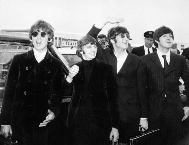 Pop group The Beatles, waving to screaming fans en route to Boston airport, America, from left to right, George Harrison, Ringo Starr, John Lennon and Paul McCartney, on August 12, 1966.