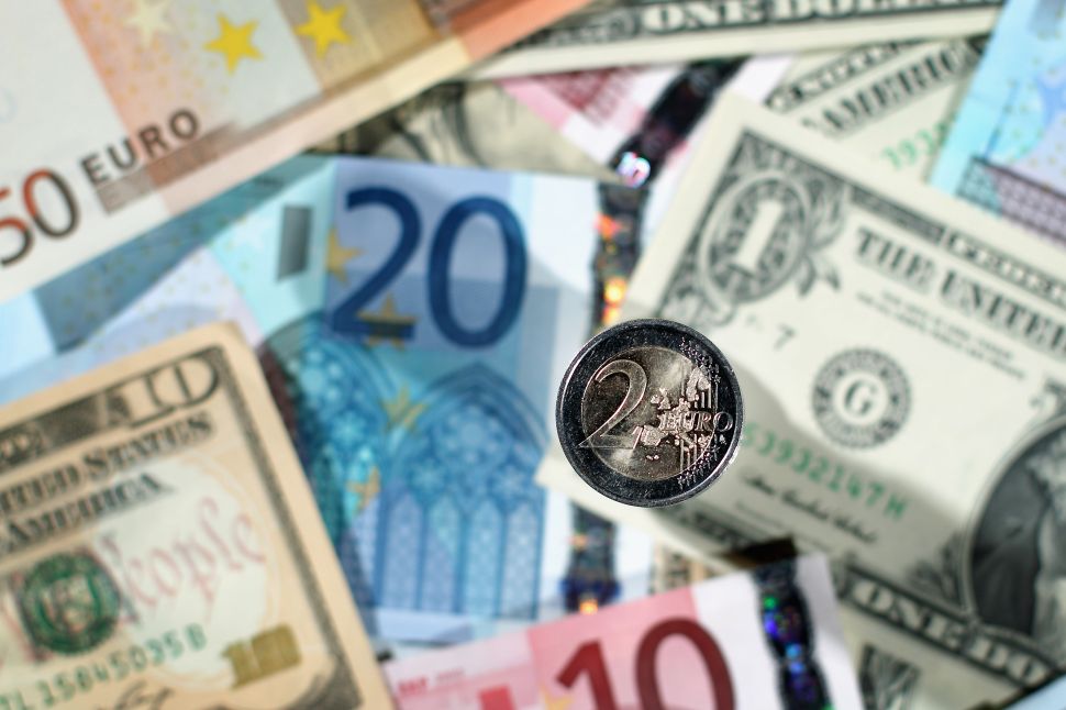 LONDON, ENGLAND - NOVEMBER 26: In this photo illustration a two Euro coin sits on a display of Dollar and Euro notes, on November 26, 2010 in London, England. Concerns over the Euro zone debts have caused shares to retreat today by 1.3 percent, as speculation continues over other countries seeking financial help. According to reports, a 85 billion euro (112.7 billion USD) rescue package from the EU and International Monetary Fund (IMF) will be announced for Ireland on Sunday.