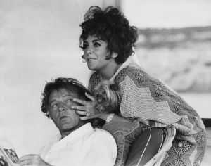 Richard Burton and Elizabeth Taylor, just relaxing on their yacht off the coast of Capo Caccia in Sardinia.
