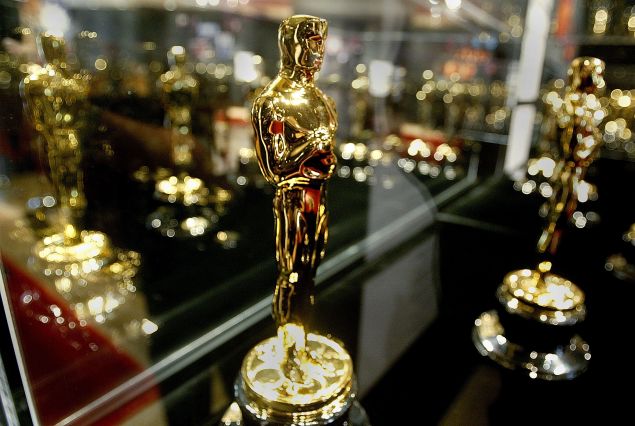 A display case full of Oscar statues.