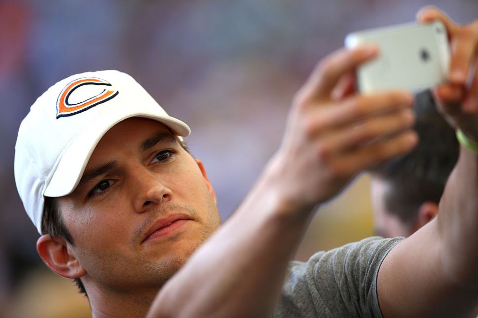 Ashton Kutcher takes a selfie.