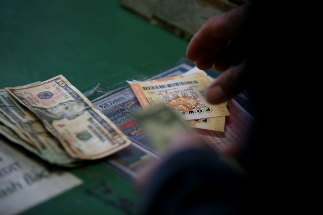 A customer buys Powerball tickets at Kavanagh Liquors on January 12, 2015 in San Lorenzo, California.