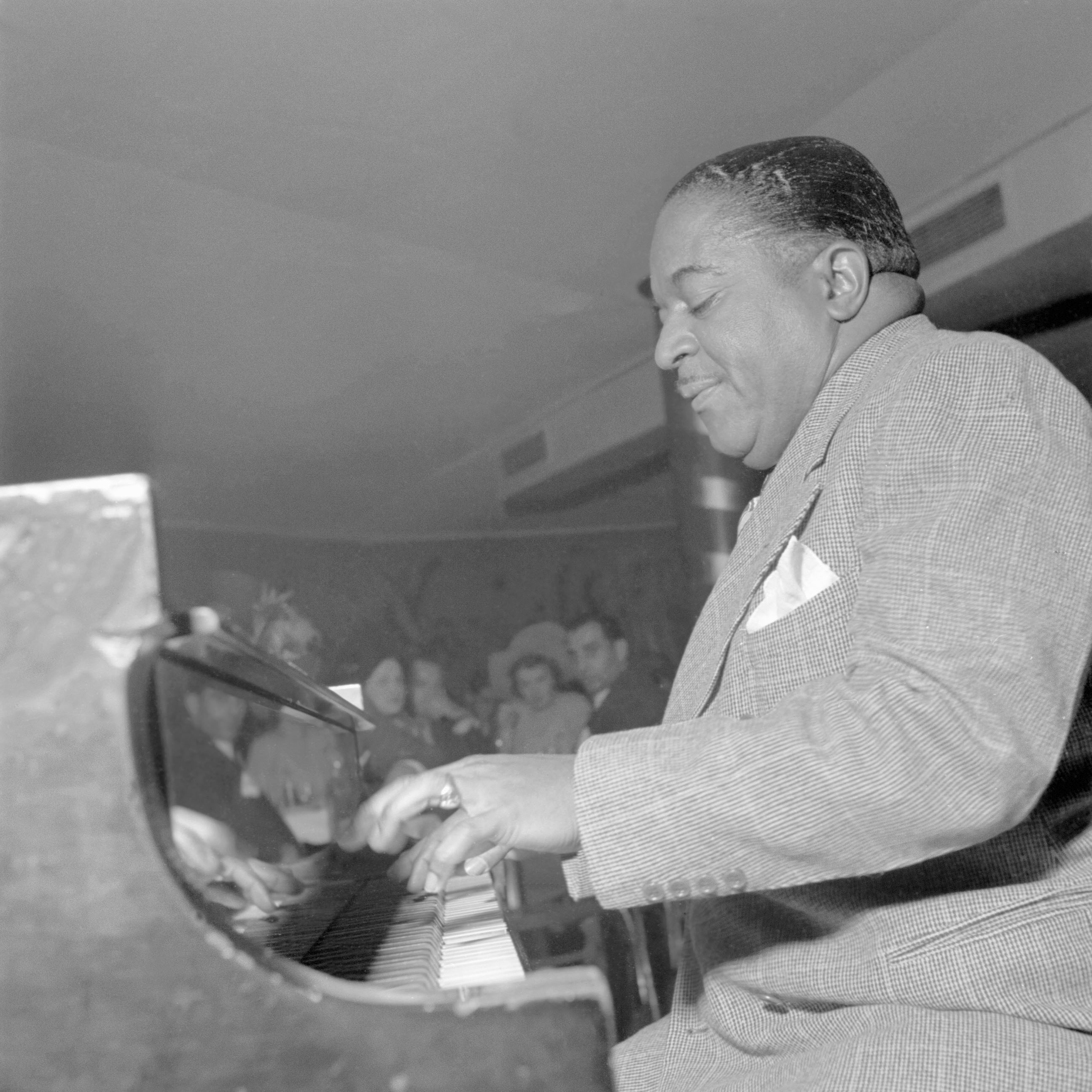 Jazz piano player Pete Johnson plays with his jazz orchestra in a New York City club in the fifties.