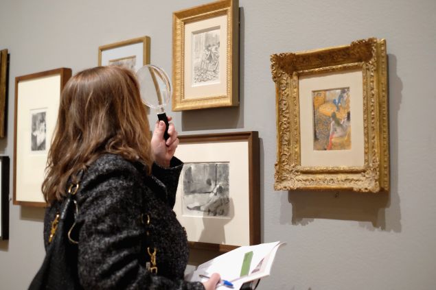 A guests views artwork by Edgar Degas on display during the "Edgar Degas: A Strange New Beauty"