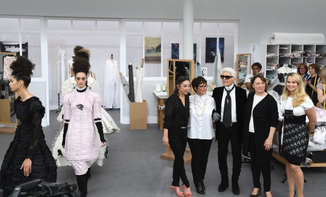 Karl Lagerfeld poses with Chanel's seamstresses