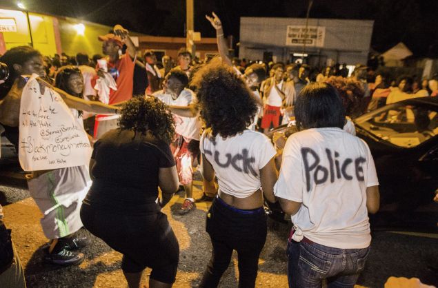 Protesters dance in the street near the convenience store where Alton Sterling was shot and killed.
