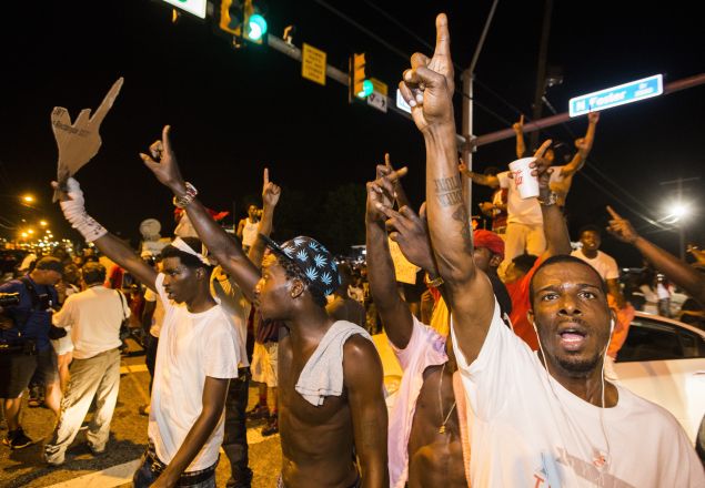 Protesters block traffic and dance on cars near the Triple S Food Mart where Alton Sterling was shot and killed.
