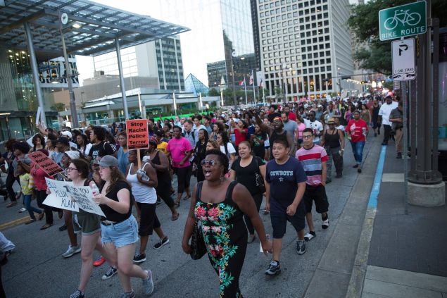 People rally in Dallas, Texas protest the deaths of Alton Sterling and Philando Castile.