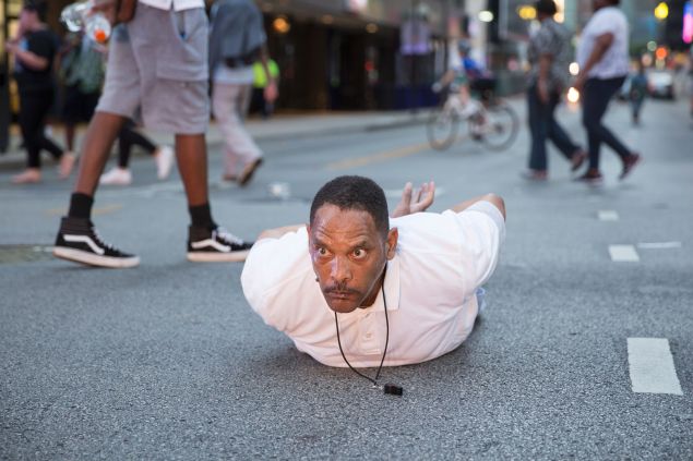 A man lays on the ground after yelling "Don't shoot me" at police during a rally in Dallas, Texas.