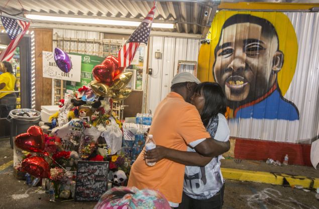 Sandra Sterling (R), Alton Sterling's aunt, visits his memorial at the store where Alton Sterling was killed. 