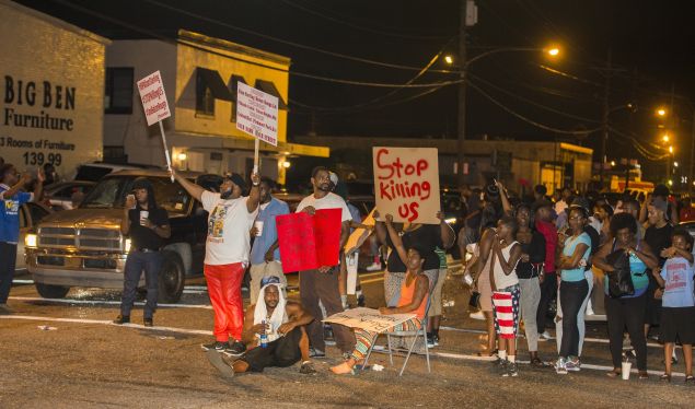 Protesters block the intersection during the third night of protest for Alton Sterling.
