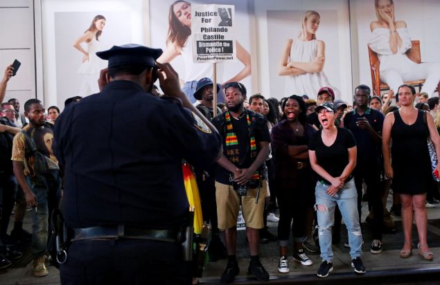 Activists protest in Times Square in response to the recent fatal shootings of two black men by police.
